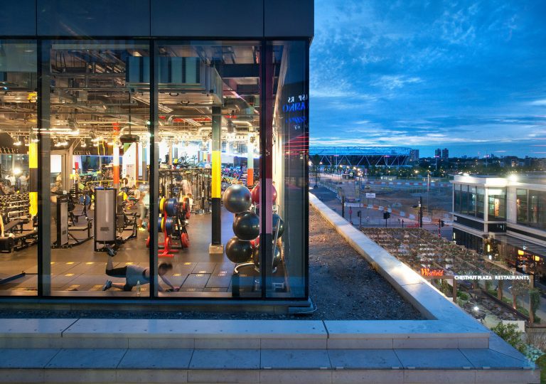 Gymbox Westfield Stratford showing the functional training area with squat racks, functional rig, and panormaic views of Olympic Park