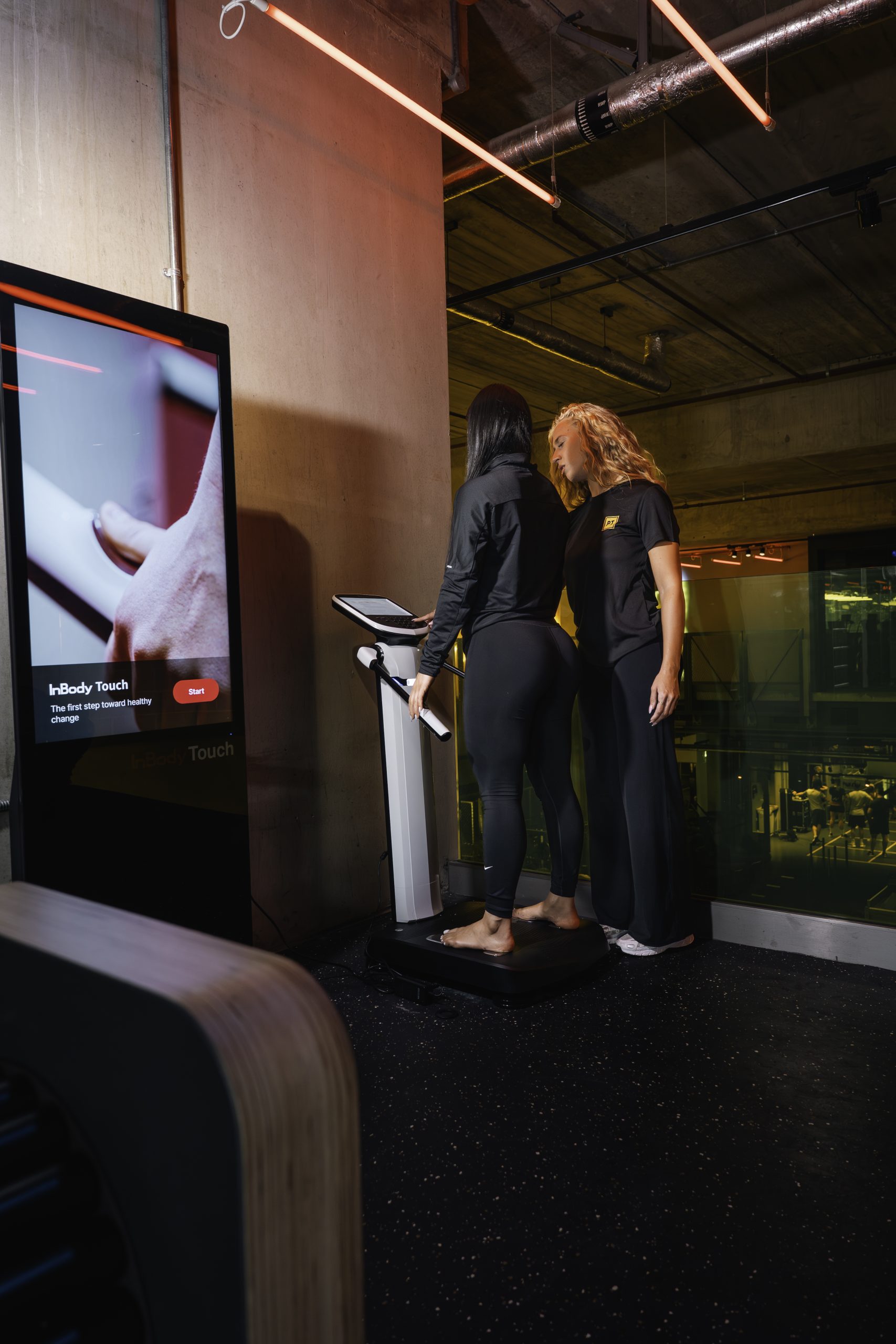 Inbody, female using the inbody scanner with a personal trainer