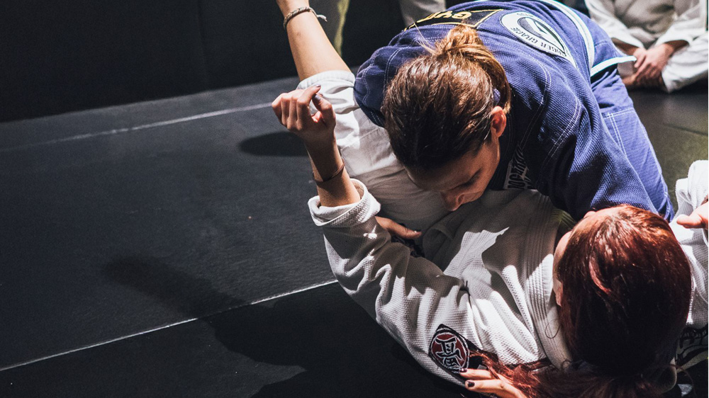 Brazilian Jiu-Jitsu - Gi, two woman on the ground.