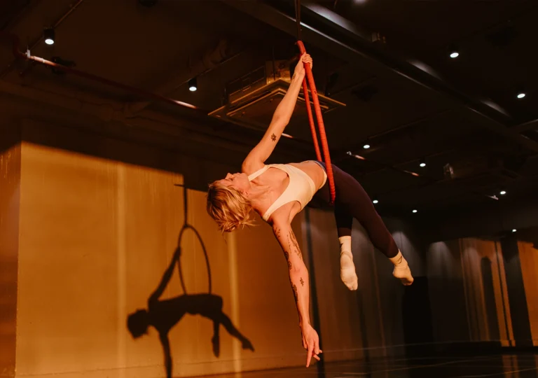 Gymbox Aerial Hoop, athlete suspends from hoop in studio