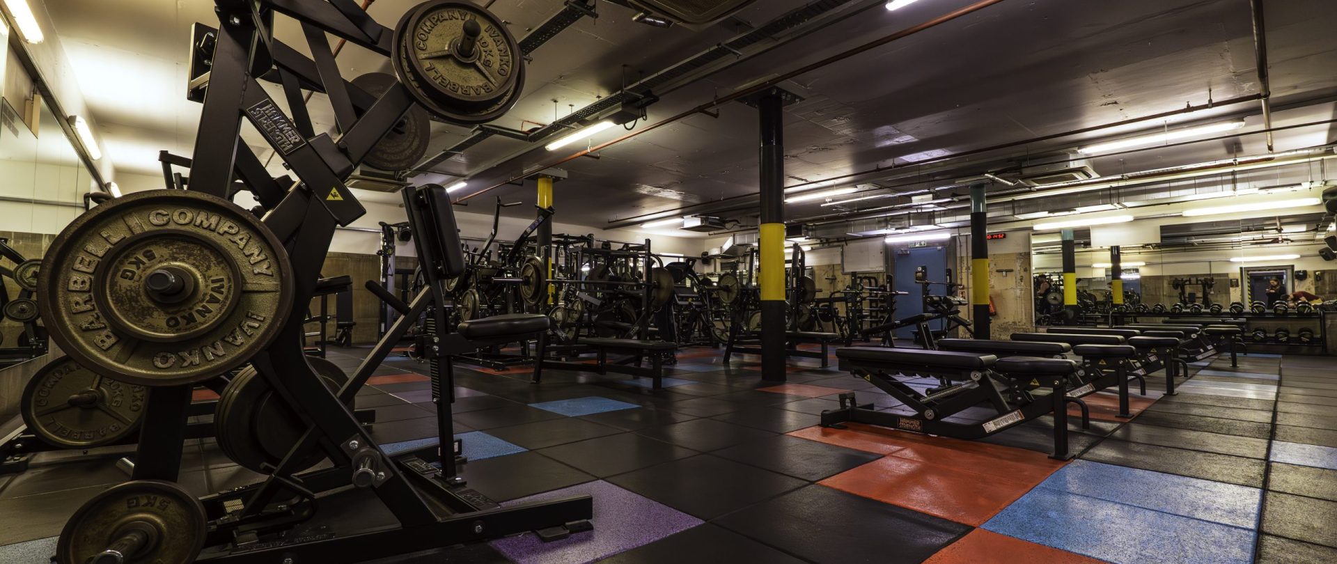 Gymbox Bank showing the free weights room with squat racks, barbells, resistance machines and dumbells - set in an old Bank vault