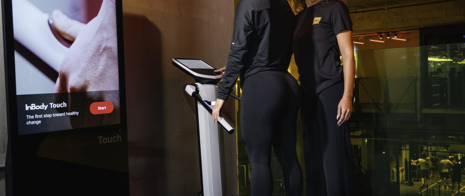 Inbody, female using the inbody scanner with a personal trainer